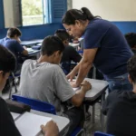 Ideb 2025 revela avanço desigual da educação em Rondônia Professora orienta alunos em sala de aula durante atividade que representa o Ideb 2025 em Rondônia.